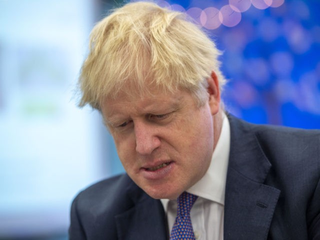 Britain's Prime Minister Boris Johnson speaks to pupils as he visits Middleton Primar