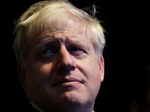 MANCHESTER, ENGLAND - SEPTEMBER 30: Prime Minister Boris Johnson listens to Sajid Javid, C