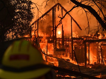 The frame of a house still stands as it burns in front of the rising sun during the Kincade fire in Healdsburg, California on October 27, 2019. - Powerful winds were fanning wildfires in northern California in "potentially historic fire" conditions, authorities said October 27, as tens of thousands of …