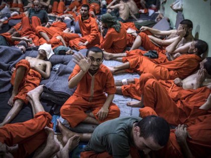 Men, suspected of being affiliated with the Islamic State (IS) group, gather in a prison c
