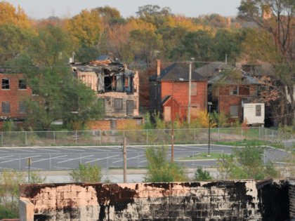 An abandoned home is seen in the background behind a derelict factory in the hard-hit indu