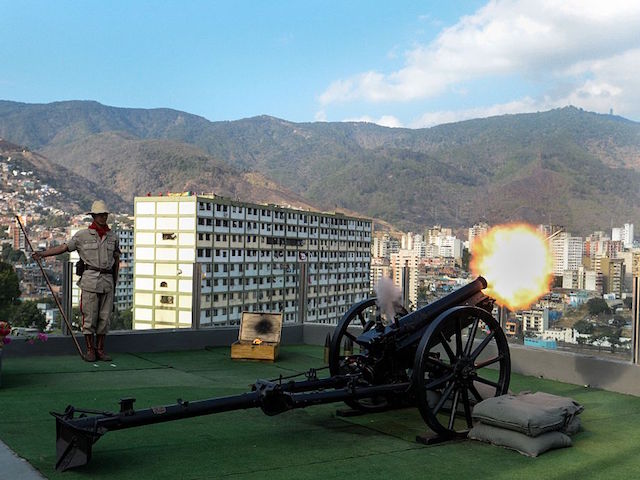 A soldier of the Bolivarian militia shoots a cannon during a ceremony for the third anniversary of late Venezuelan President Hugo Chavez's death at the Cuartel de la Montana barracks in Caracas on March 5, 2016. AFP PHOTO/FEDERICO PARRA / AFP / FEDERICO PARRA (Photo credit should read FEDERICO PARRA/AFP/Getty Images)