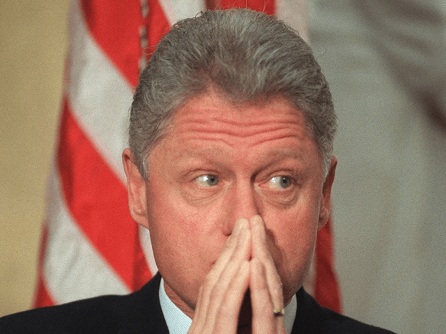 US President Bill Clinton listens during ceremonies for former Agriculture Secretary Mike