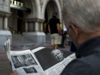 WASHINGTON, DC - OCTOBER 26: A man reads an article by The New York Times on Donald Trump during a protest outside the new Trump International Hotel at the old post office on October 26, 2016 in Washington, D.C. Republican presidential nominee Donald Trump will attend the hotel's grand opening. …