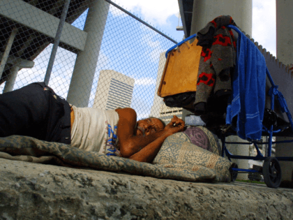 Belede Martinez, who is homeless, sleeps November 20, 2001 on a sidewalk in Miami, Florida