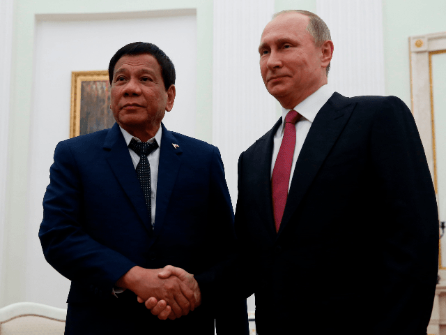 Russian President Vladimir Putin (R) shakes hands with his Philippine counterpart Rodrigo Duterte during a meeting in Moscow late on May 23, 2017. / AFP PHOTO / POOL / MAXIM SHEMETOV (Photo credit should read MAXIM SHEMETOV/AFP/Getty Images)