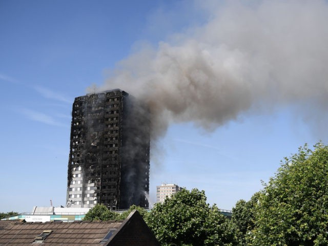 LONDON, ENGLAND - JUNE 14: Fire fighters tackle the building after a huge fire engulfed t