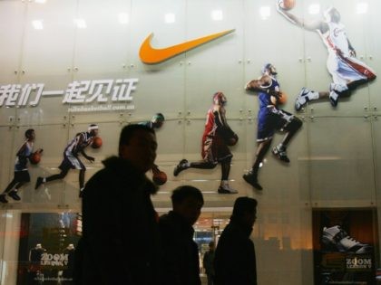 BEIJING - DECEMBER 26: People pass by the Nike shop on December 26, 2007 in Beijing, China. The Beijing Olympic Games will bring enormous commercial opportunity to Beijing. (Photo by Feng Li/Getty Images)