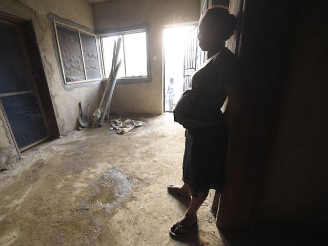 A pregnant Cameroonian refugee lean on the wall in a house, where hundreds are being sheltered at Bashu in Boki district of Cross Rivers State in southeast Nigeria, on January 31, 2018.
