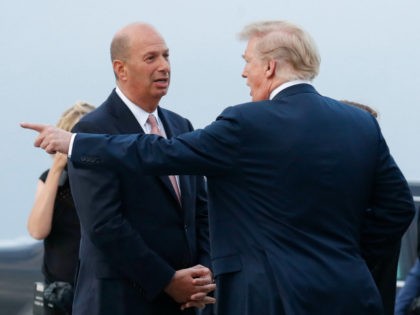 President Donald Trump, right, walks on the tarmac with the U.S. ambassador to European Un