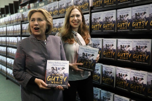 NEW YORK, NEW YORK - OCTOBER 03: Chelsea and Hillary Clinton pose with their new book "The Book of Gutsy Women" on October 03, 2019 in New York City. The new book by mother and daughter co-authors celebrates women in history, many of whom have been overlooked, that have stood …