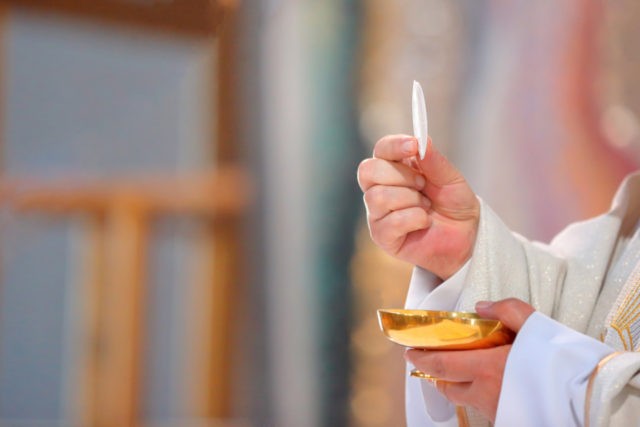 Priest celebrate mass at the church and empty place for text"n"n