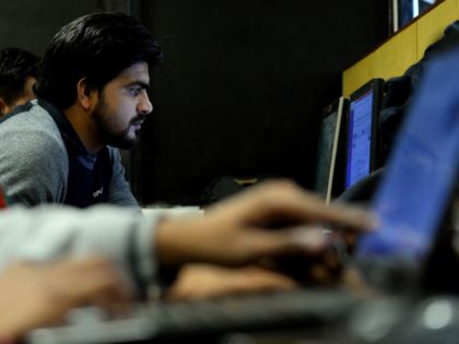 In this photograph taken on December 13, 2016, an employee of Indian IT security solutions company Innefu Labs works at their offices in New Delhi. In the darkened offices of a tech start-up, a handful of computer engineers sift through a mountain of intelligence data that would normally be the …