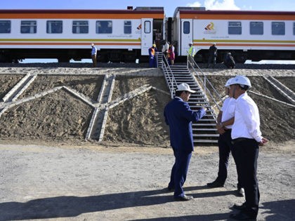 Contractors from China Commmunication Construction Company (CCCC) stand next to the Standard Gauge Railway (SGR) train at Mai Mahiu, on October 16, 2019. (Photo by SIMON MAINA / AFP) (Photo by SIMON MAINA/AFP via Getty Images)