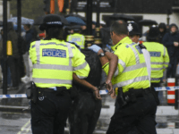 Police and medics respond to an incident outside the gates of the Houses of Parliament, in London, Tuesday, Oct. 1, 2019. Police in London have detained a man near the Houses of Parliament after he doused himself in what appeared to be flammable liquid. (AP Photo/Alberto Pezzali)