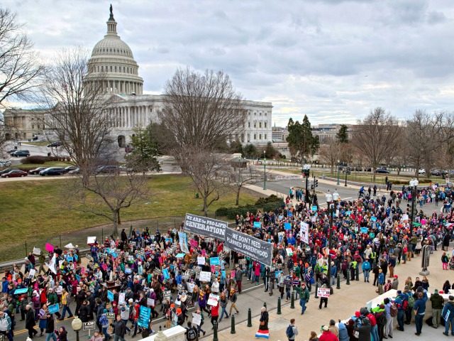 In this Friday, Jan. 27, 2017 file photo, anti-abortion demonstrators arrive on Capitol Hill in Washington during the March for Life, marking the anniversary of the 1973 Supreme Court decision legalizing abortion. Organizers say Donald Trump will become the first sitting president to address the 2018 March for Life gathering, …