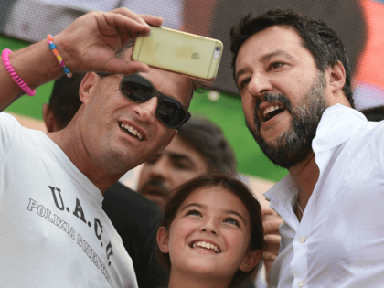 Supporters take a selfie photo with Italian senator, head of the Italian far-right League (Lega) party Matteo Salvini (R) on stage after he delivered a speech at the party's annual rally in Pontida on September 15, 2019. (Photo by Miguel MEDINA / AFP) (Photo credit should read MIGUEL MEDINA/AFP/Getty Images)