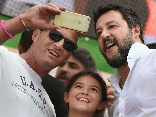 Supporters take a selfie photo with Italian senator, head of the Italian far-right League (Lega) party Matteo Salvini (R) on stage after he delivered a speech at the party's annual rally in Pontida on September 15, 2019. (Photo by Miguel MEDINA / AFP) (Photo credit should read MIGUEL MEDINA/AFP/Getty Images)