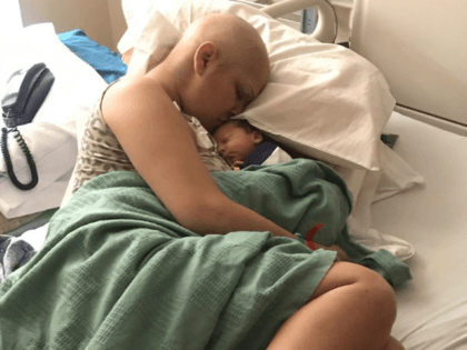 Jade Devis, a patient with Stage 2 triple negative breast cancer, kisses her newborn right after giving birth. Devis had to undergo chemotherapy during her pregnancy and never knew if her son would survive her treatment. (Courtesy of Loma Linda University Health)