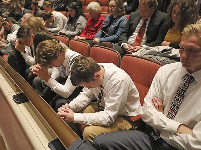 People pray during The Church of Jesus Christ of Latter-day Saints' twice-annual church co
