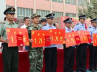 This picture taken on August 3, 2014 shows uniformed personnel during an awarding ceremony for those who helped in the killing and capture of 10 "suspected terrorists" in Moyu county in Hotan prefecture, northwest China's Xinjiang region. China is offering more than 300 million yuan ($49 million) for residents of …