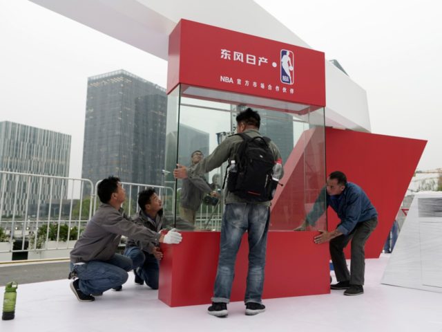Workers dismantle signage for an NBA fan event scheduled to be held on Wednesday night at the Shanghai Oriental Sports Center in Shanghai, China, Tuesday, Oct. 8, 2019. Chinese state broadcaster CCTV announced Tuesday it will no longer air two NBA preseason games set to be played in the country. …