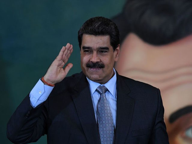 TOPSHOT - Venezuelan President Nicolas Maduro salutes after a press conference in Caracas