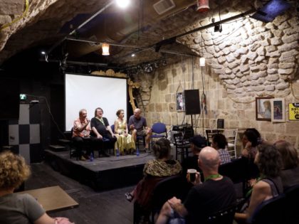 Israeli artist Oded Kotler (on stage 2 L), the founder of the Akko (Acre in Hebrew) Fringe Theatre Festival takes part in a discussion panel during the festival in Acre on October 16, 2019. - Kotler, who won the award for Best Actor at the 1967 Cannes Film Festival for …