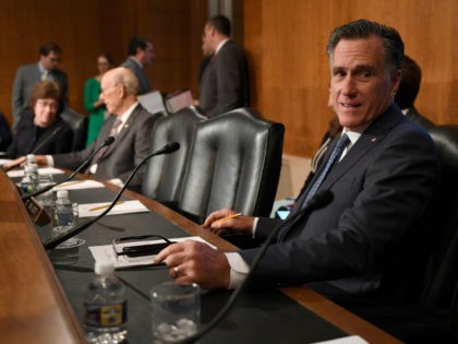 Sen. Mitt Romney, R-Utah, talks with a colleague during a break in an executive session of the Senate Health, Education, Labor and Pensions Committee on Capitol Hill in Washington, Tuesday, Sept. 24, 2019. The committee voted to advance Scalia's nomination to the full Senate for consideration. (AP Photo/Susan Walsh)