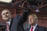 US President Donald Trump (R) listens as GOP Senatorial Candidate Matt Rosendale (L) speaks during a "Make America Great Again" rally in Great Falls, Montana, on July 5, 2018. (Photo by JIM WATSON / AFP) (Photo credit should read JIM WATSON/AFP/Getty Images)