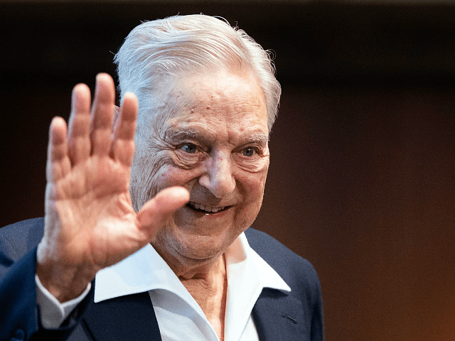 George Soros talks to the audience after receiving the Schumpeter …