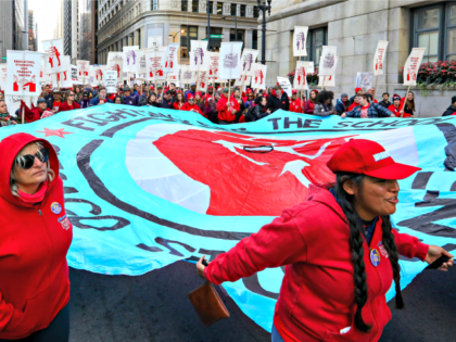 Teachers, staff and their supporters march through downtown Chicago, Monday, Oct. 14, 2019. The teachers are calling for district leaders to meet their demands on class sizes just days before a threatened strike that would affect thousands of students in the country's third-largest school district. (AP Photo/Teresa Crawford)