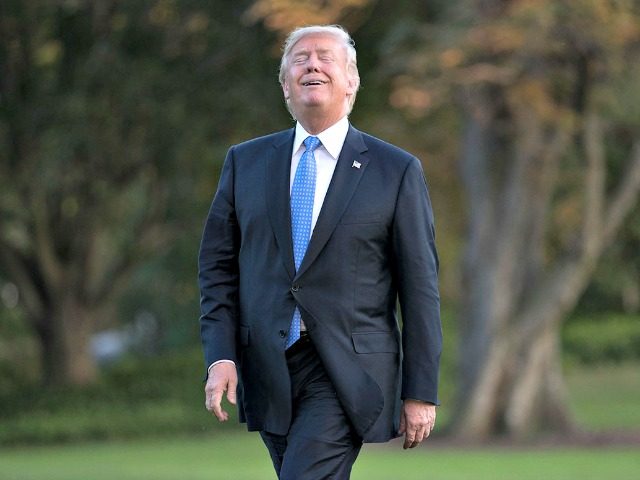 Trump laughs as he walks from Marine One across the South Lawn to the White House on Wedne