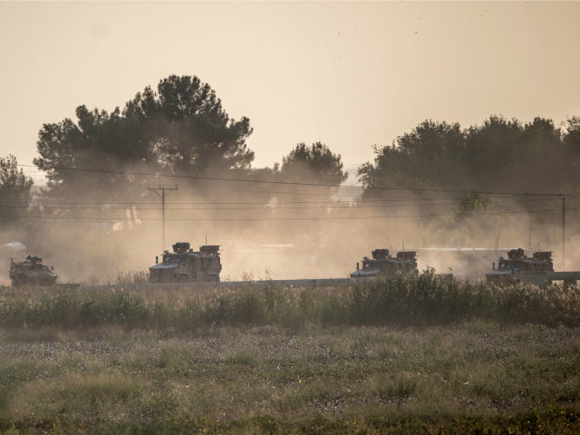 Turkish army vehicles drive towards the Syrian border near Akcakale in Sanliurfa province