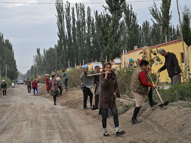 This photo taken on September 13, 2019 shows people on a street in a small village where ethnic Uighurs live on the outskirts of Shayar in the region of Xinjiang. (Photo by HECTOR RETAMAL / AFP) (Photo by HECTOR RETAMAL/AFP via Getty Images)