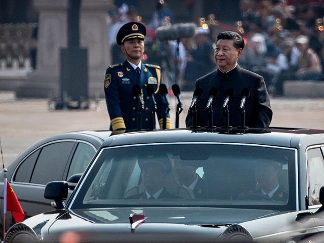 BEIJING, CHINA - OCTOBER 01: Chinese President Xi Jinping drives in a Hong Qi car after inspecting the troops during a parade to celebrate the 70th Anniversary of the founding of the People's Republic of China at Tiananmen Square in 1949, on October 1, 2019 in Beijing, China. (Photo by …