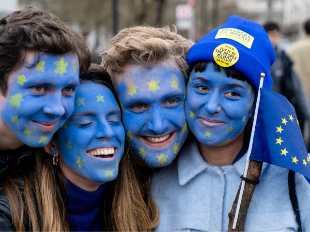 TOPSHOT - People with their faces painted in European flag colours attend a rally organise