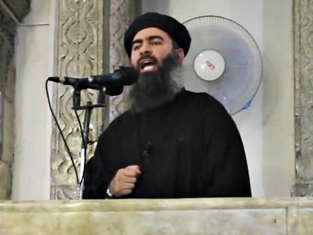 This file image made from video posted on a militant website July 5, 2014, which has been authenticated based on its contents and other AP reporting, purports to show the leader of the Islamic State group, Abu Bakr al-Baghdadi, delivering a sermon at a mosque in Iraq. (Militant video/AP)