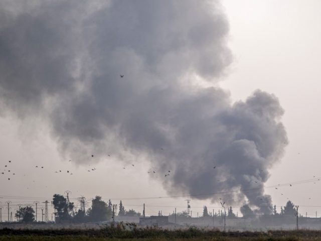 TOPSHOT - Smoke rises from the Syrian town of Tal Abyad after Turkish bombings, in a pictu