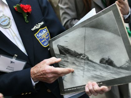 WASHINGTON, DC - JUNE 04: WWII submarine veteran Henry Kudzik sits with other veterans while holding a Life magazine picture of a Japanese ship sinking after being torpedoed by the U.S.S. Nautlis, during a ceremony and commemoration of the 70th anniversary of the Battle of Midway at the U.S. Navy …