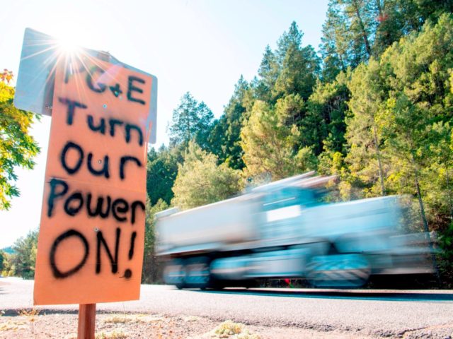 A sign calling for PG&E to turn the power back on is seen on the side of the road during a statewide blackout in Calistoga, California, on October, 10, 2019 - Rolling blackouts set to affect millions of Californians began October 9, as Pacific Gas & Electric started switching off …