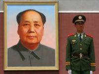 A Chinese paramilitary soldier stands guards in front of a new giant portrait of former Chinese leader Mao Zedong on display at Tiananmen Square in Beijing, 13 May 2007. Police 12 May detained an unemployed man who tried to set fire to the famed giant portrait of Chinese revolutionary leader …