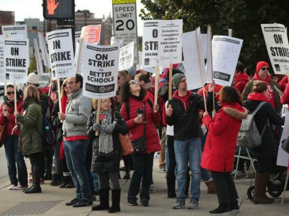 CHICAGO, ILLINOIS - OCTOBER 17: Chicago public school teachers and their supporters picket outside of Lane Tech College Prep high school on October 17, 2019 in Chicago, Illinois. About 25,000 Chicago school teachers went on strike today after the Chicago Teachers Union (CTU) failed to reach a contract agreement with …