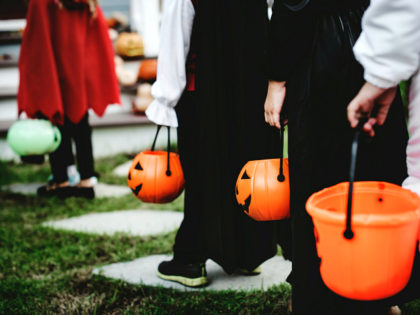 Little children in Halloween costumes - stock photo