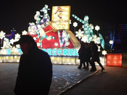 Visitors walk past a Beijing Olympics-themed lantern in a park in Yuzhou town, Yu county,