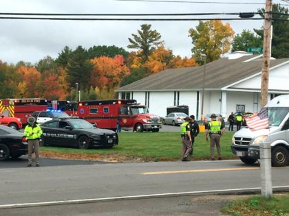 In this photo provided by WMUR-TV, police stand outside the New England Pentecostal Church on Saturday, Oct. 12, 2019, in Pelham, N.H. (Siobhan Lopez/WMUR-TV via AP)