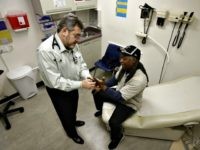 In this photo taken Thursday, Feb. 18, 2016, Doctor Leonid Basovich, left, examines Medi-Cal patient Michael Epps, at the WellSpace Clinic in Sacramento, Calif. (Rich Pedroncelli/AP)