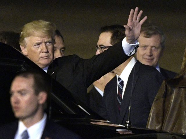 US President Donald Trump (L) waves shortly after landing at Ezeiza International airport