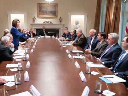 In this photo released by the White House, President Donald Trump, center right, meets wit