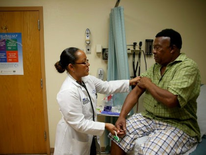 HOLLYWOOD, FL - APRIL 15: Felue Chang who is newly insured under an insurance plan through the Affordable Care Act receives a checkup from Dr. Peria Del Pino-White at the South Broward Community Health Services clinic on April 15, 2014 in Hollywood, Florida. A report released by the Congressional Budget …